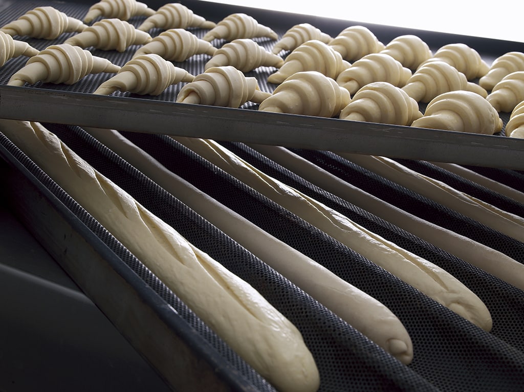 Trays With Frozen Croissants And Baguettes