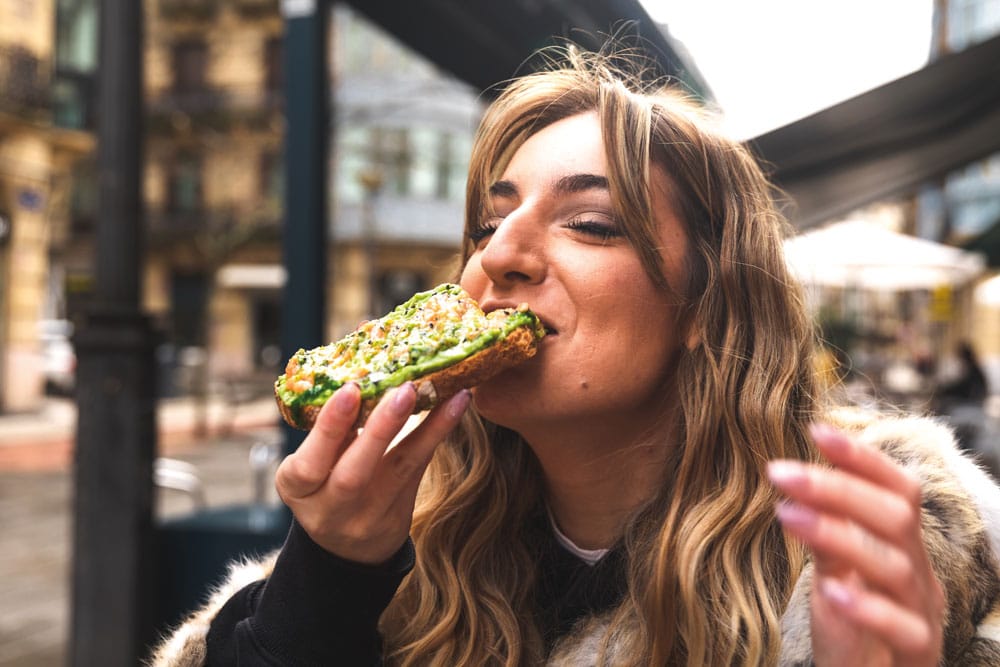 woman eating sourdough toast with salmon